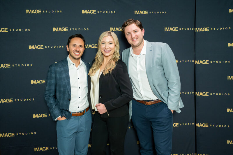 Three smiling professionals stand in front of an "IMAGE STUDIOS" branded backdrop
